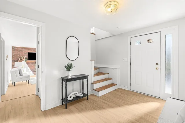 a view of a room with wooden floor and white walls