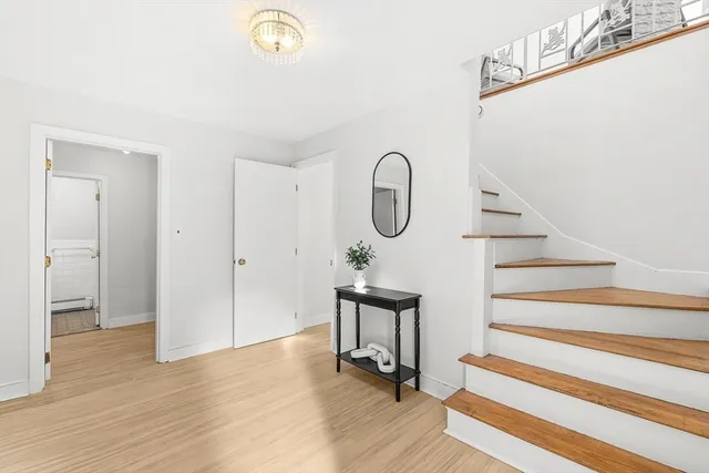 a view of entryway and hall with wooden floor