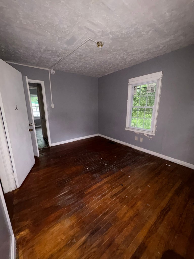 702 Lawyers Lane Columbus, GA 31906 - Photo 15 of 17 a view of an empty room with wooden floor and a window