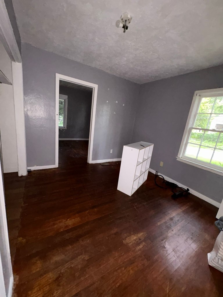 702 Lawyers Lane Columbus, GA 31906 - Photo 7 of 17 a view of an empty room and wooden floor