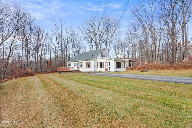 a view of a house with swimming pool and sitting area