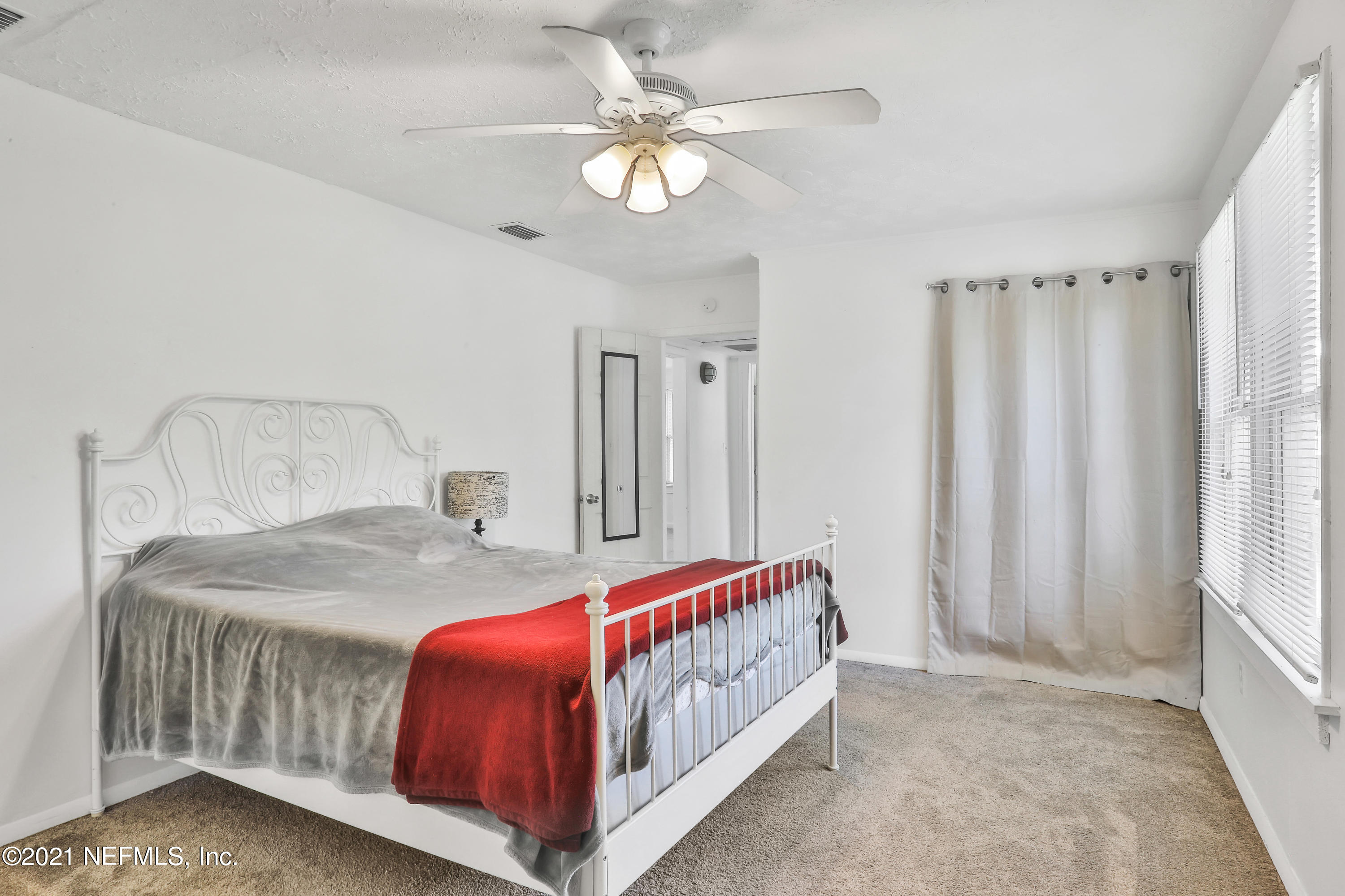 6125 Seaboard Avenue Jacksonville, FL 32244 - Photo 5 of 18 a bed sitting in a bedroom next to a window