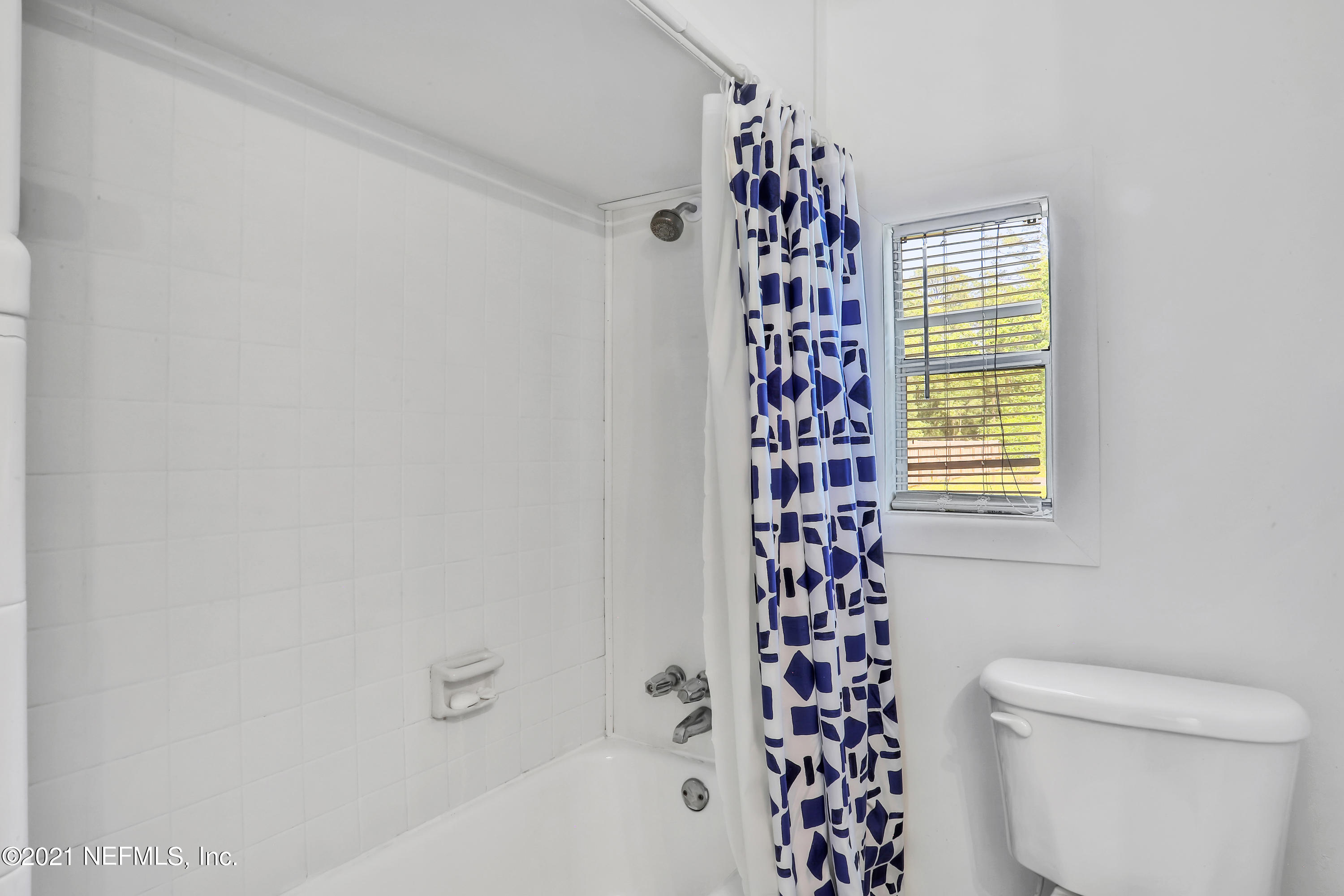 6125 Seaboard Avenue Jacksonville, FL 32244 - Photo 7 of 18 a bathroom with a bathtub and a shower curtain