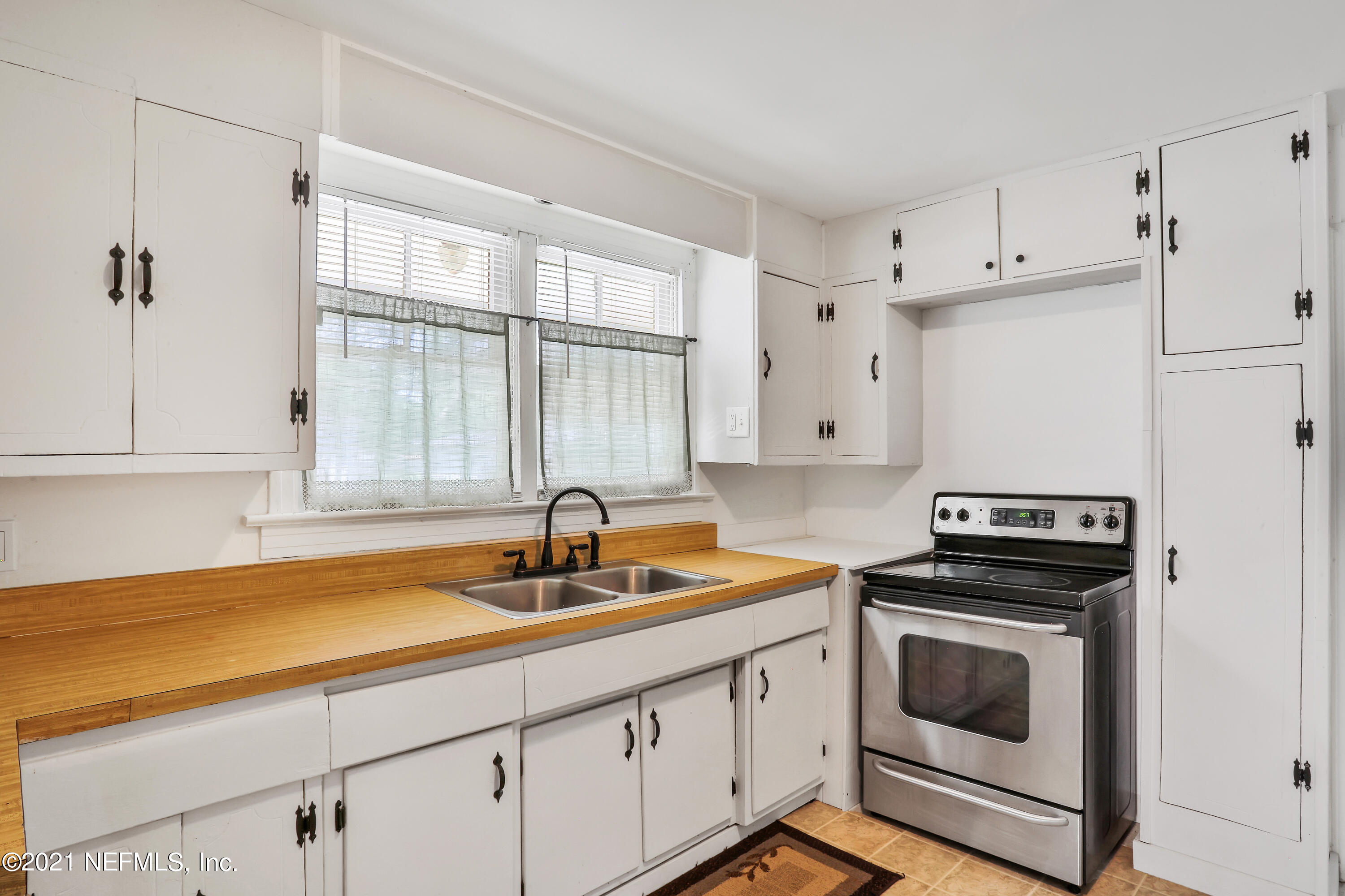 6125 Seaboard Avenue Jacksonville, FL 32244 - Photo 8 of 18 a kitchen with white cabinets and white appliances