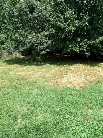a view of a swimming pool with an outdoor space and seating area