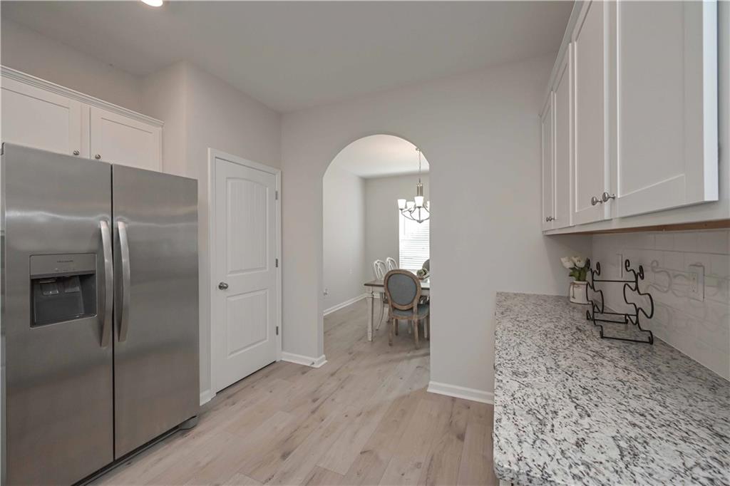 505 Charleston Place Villa Rica, GA 30180 - Photo 15 of 35 a kitchen with granite countertop a refrigerator and a sink