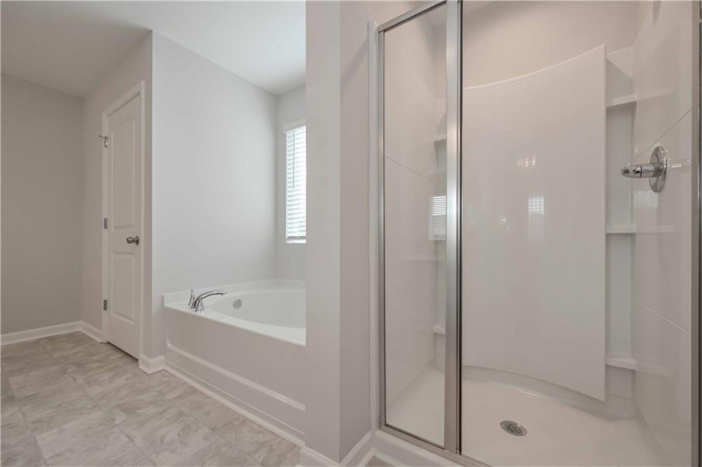 505 Charleston Place Villa Rica, GA 30180 - Photo 31 of 35 a bathroom with a bathtub and a shower