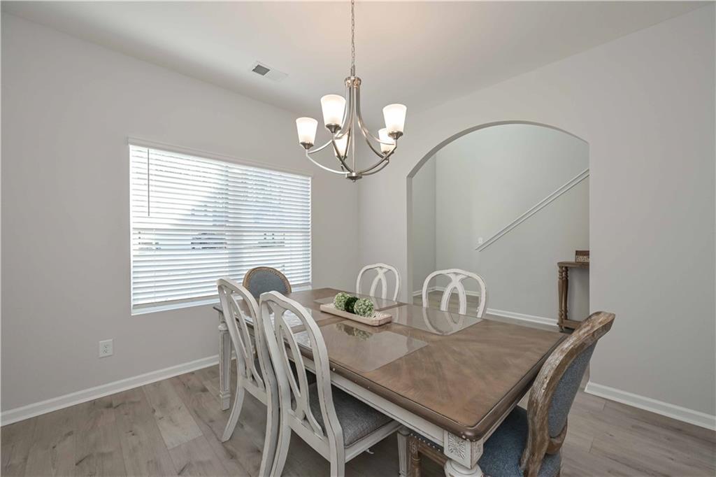 505 Charleston Place Villa Rica, GA 30180 - Photo 7 of 35 a dining room with furniture a chandelier and window