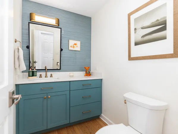 a bathroom with a toilet a sink and mirror
