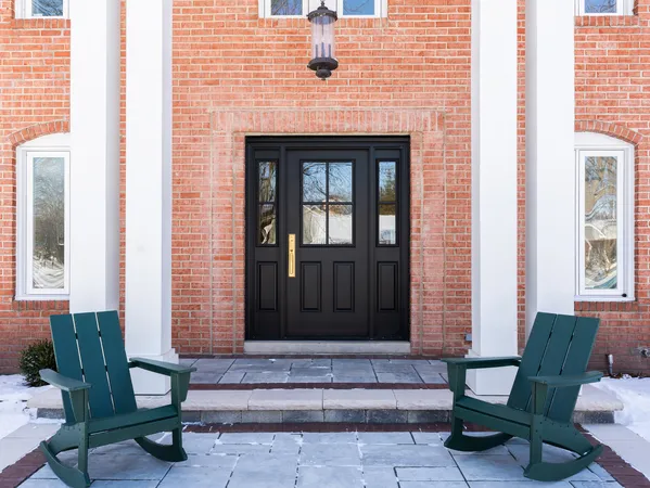 a front view of a house with a chairs and table