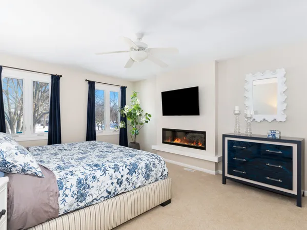 a bedroom with a bed and a fireplace