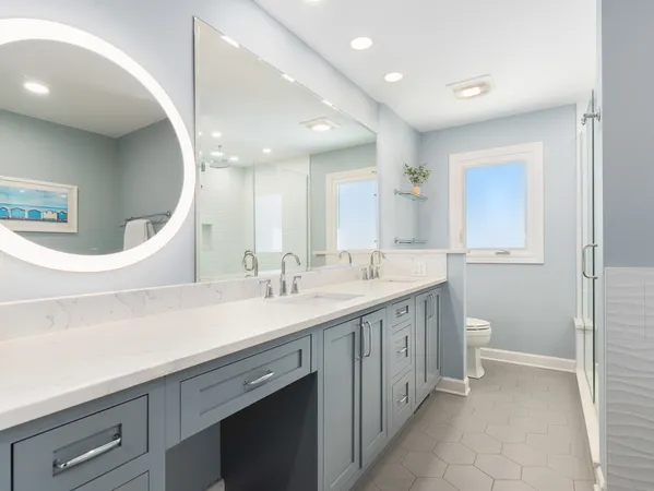 a spacious bathroom with a double vanity sink and a mirror
