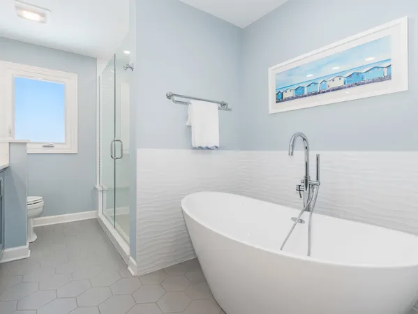 a white bath tub sitting next to a white toilet
