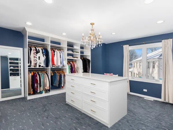 a view of a walk in closet and a window