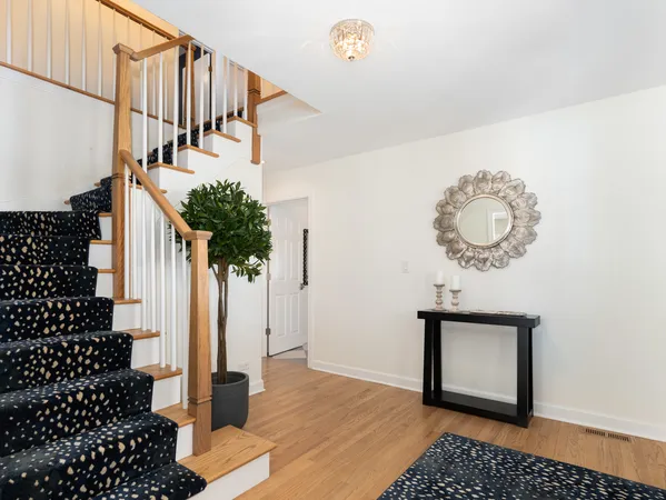 a view of entryway and hall with wooden floor
