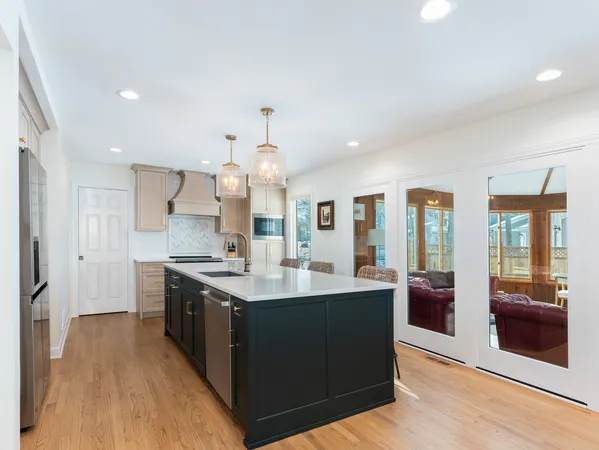 a kitchen with stainless steel appliances granite countertop a sink and a refrigerator