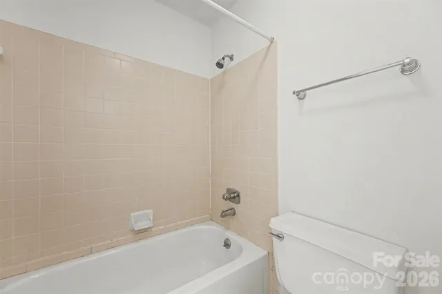 a bathroom with a bathtub and a toilet