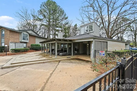 a front view of a house with a yard and potted plants