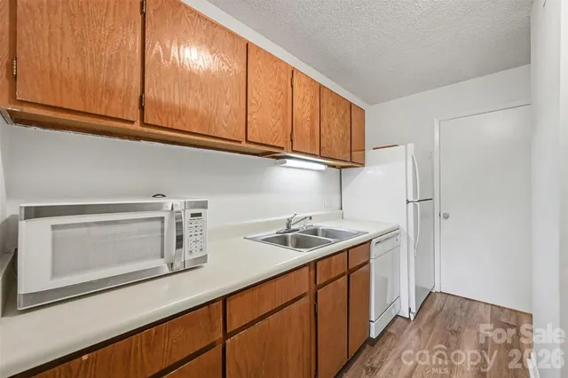 a kitchen with stainless steel appliances granite countertop a sink and cabinets