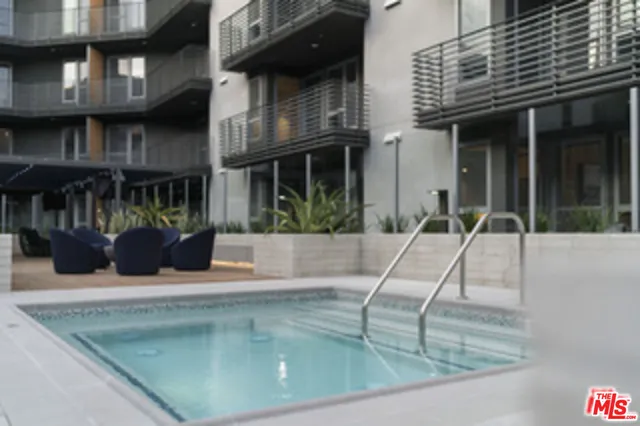 a building outdoor space with patio furniture and a fireplace