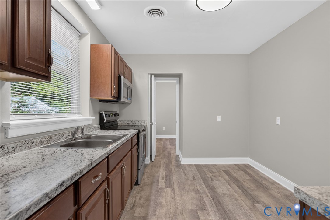 1118 Andros Road Richmond, VA 23225 - Photo 10 of 28 kitchen featuring rich wood cabinetry, stainless s