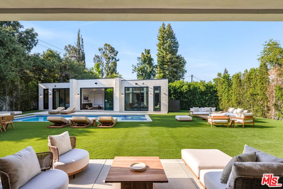 17055 Rancho Street Encino, CA 91316 - Photo 52 of 73 a view of a house with backyard sitting area and garden