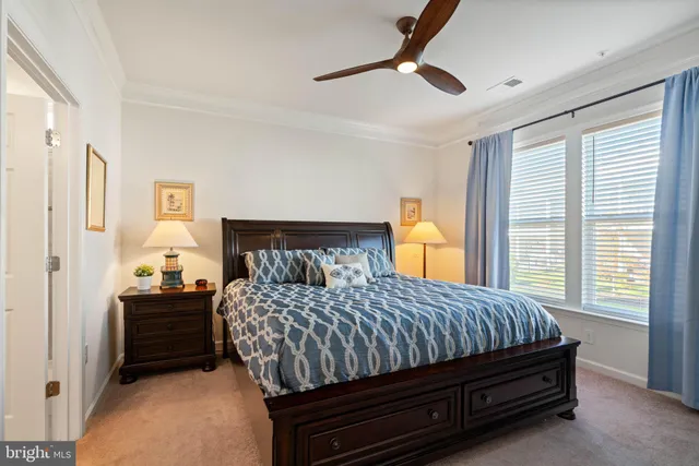 a bedroom with a bed and a dresser next to a window