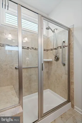 a bathroom with a glass shower door