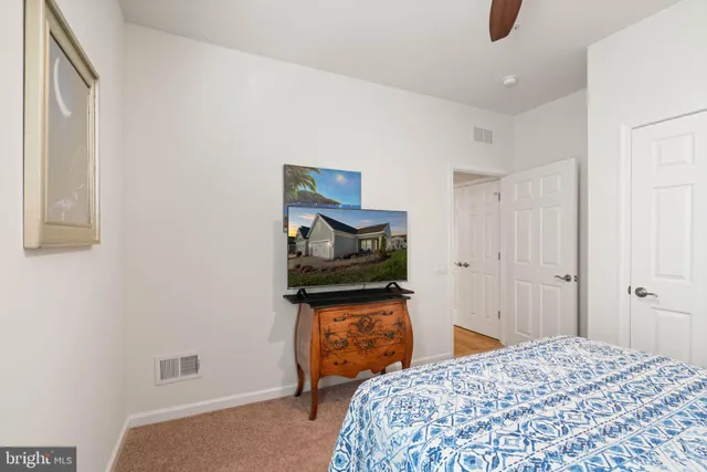 a bedroom with a bed and a painting on the wall