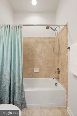 a bathroom with a shower and a bath tub