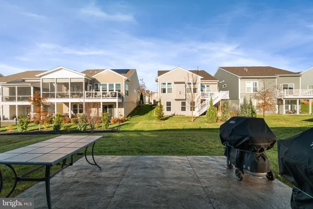a front view of a house with a yard table and chairs