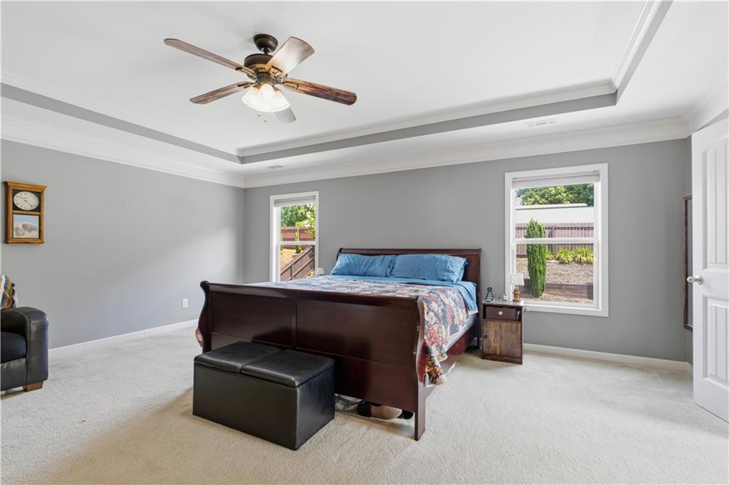 5825 Willow Oak Pass Cumming, GA 30040 - Photo 26 of 55 a bedroom with a bed and a chandelier