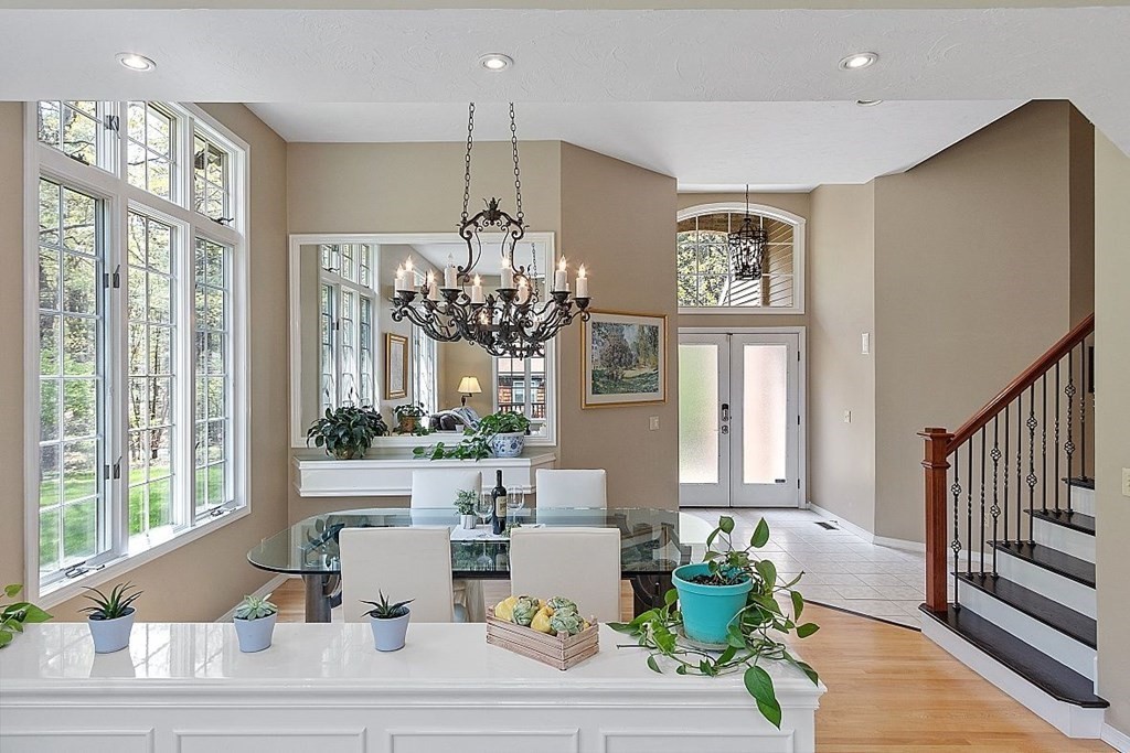 793 Reservoir Road Lunenburg, MA 01462 - Photo 23 of 39 a view of a dining room with furniture a chandelier and large windows