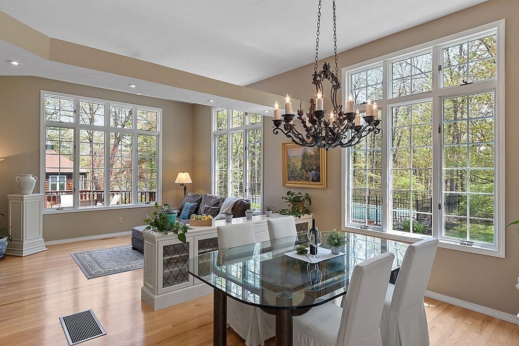 793 Reservoir Road Lunenburg, MA 01462 - Photo 27 of 39 a view of a dining room with furniture a chandelier and wooden floor