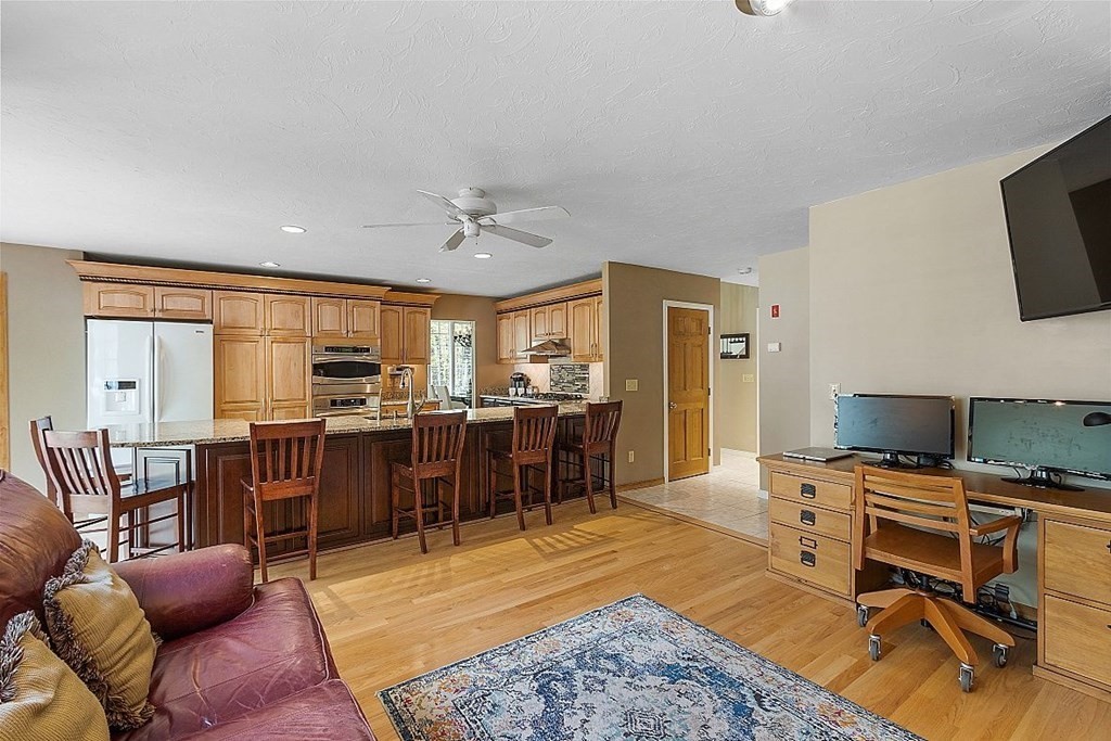 793 Reservoir Road Lunenburg, MA 01462 - Photo 28 of 39 a living room with furniture a flat screen tv and appliances