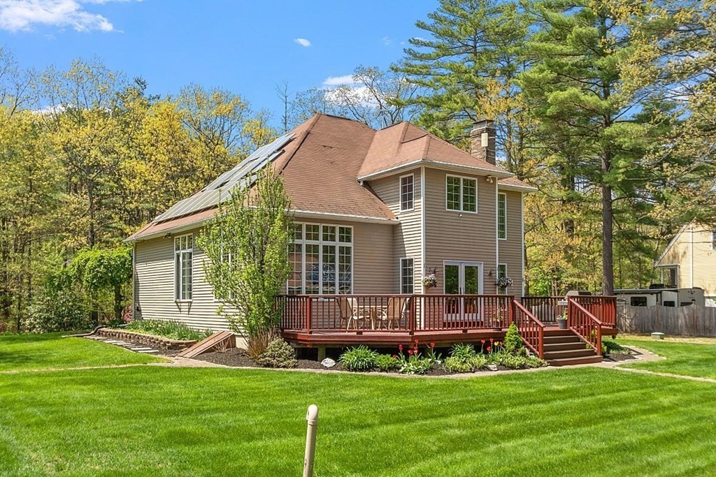 793 Reservoir Road Lunenburg, MA 01462 - Photo 29 of 39 a front view of a house with a garden