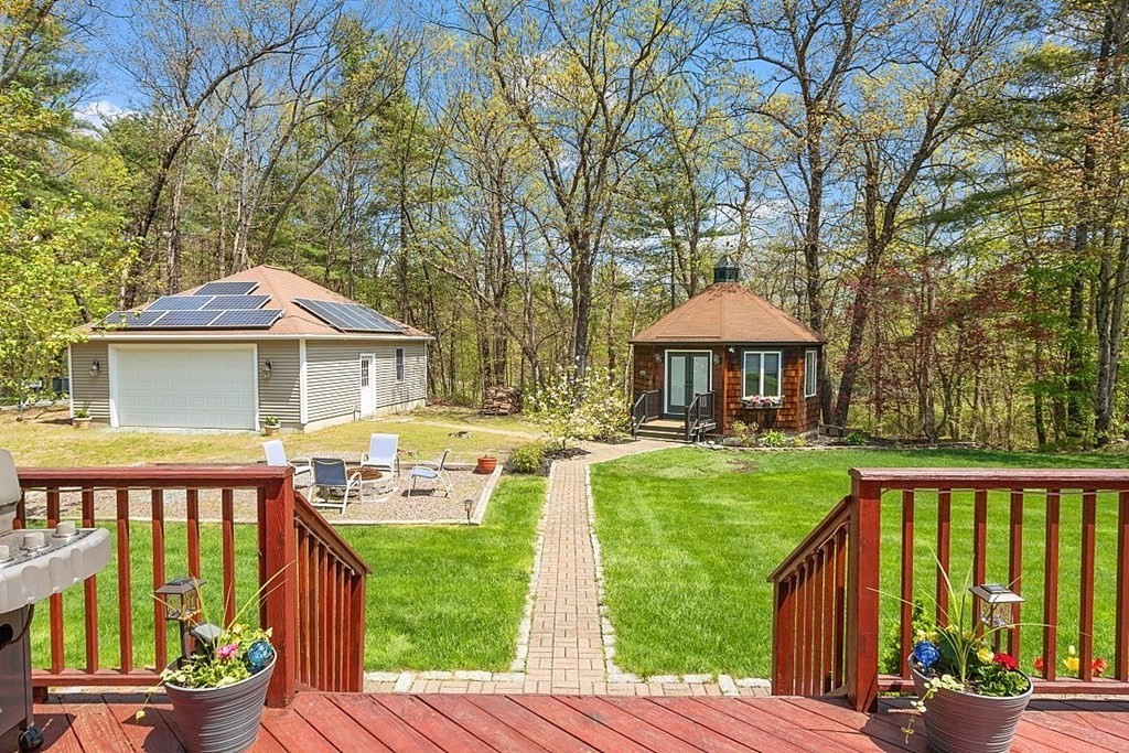 793 Reservoir Road Lunenburg, MA 01462 - Photo 32 of 39 a front view of a house with a yard table and chairs