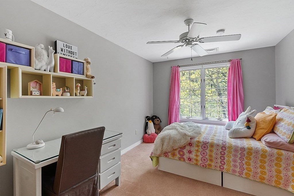 793 Reservoir Road Lunenburg, MA 01462 - Photo 34 of 39 a bedroom with a bed and a chandelier