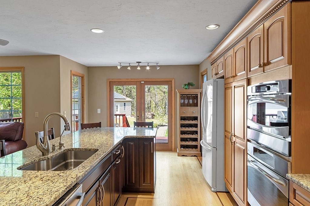 793 Reservoir Road Lunenburg, MA 01462 - Photo 9 of 39 a kitchen with granite countertop a refrigerator and a sink