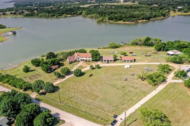 an aerial view of a house with a lake view