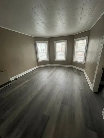 a living room with wooden floor and furniture