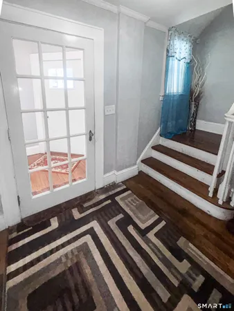 a view of a room with wooden floor and windows