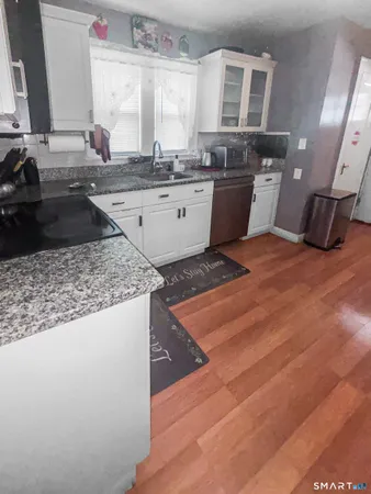 a kitchen with a sink appliances and cabinets