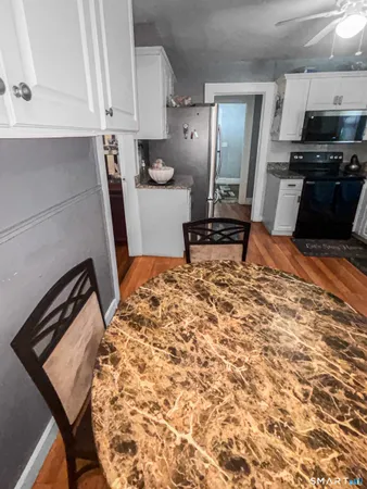 a kitchen with granite countertop a stove and a sink