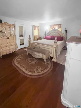 a view of a bedroom with a bed and lamp