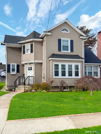 a front view of a house with a garden and yard