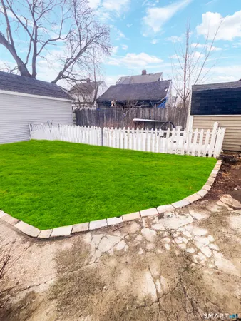a view of yard with swimming pool and green space