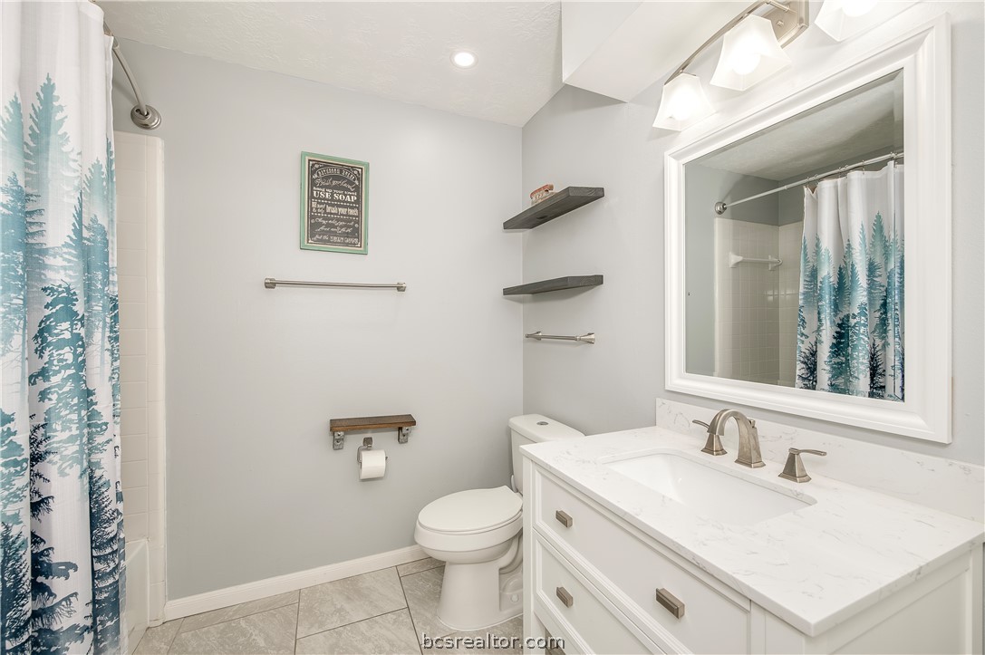 2009 Cobblestone Lane Bryan, TX 77807 - Photo 19 of 23 a bathroom with a sink vanity mirror and toilet