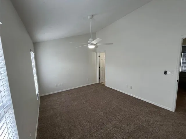 a view of a room with a ceiling fan