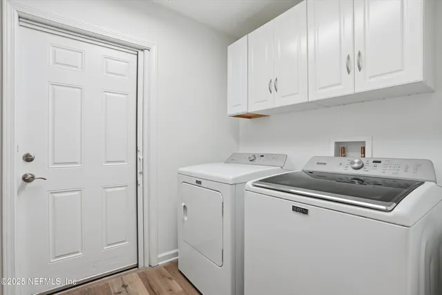 a utility room with sink dryer and washer